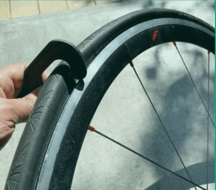 A TyreKey being used to get a tyre back onto a rim