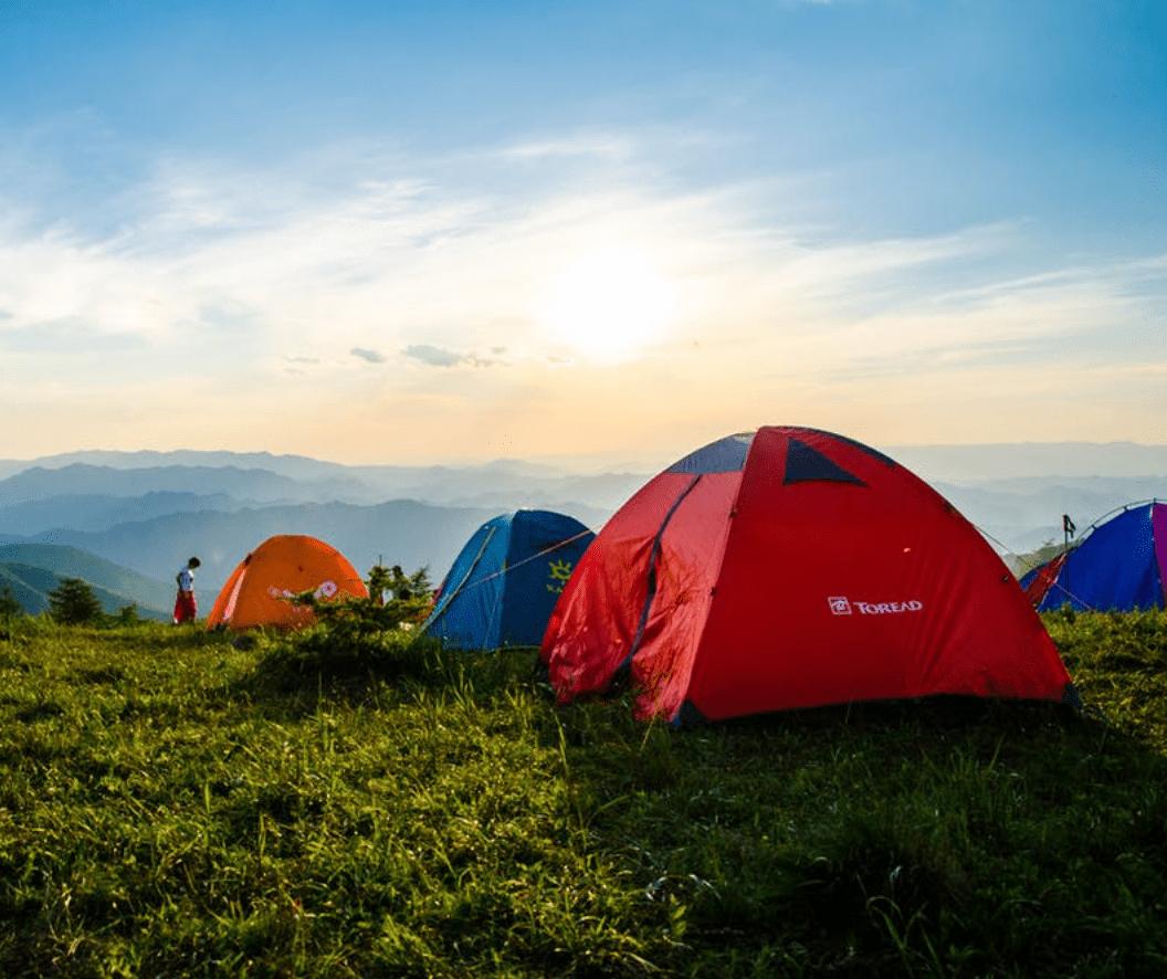 A cluster of dome tents on a mountainside